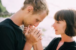man kissing woman's hands
